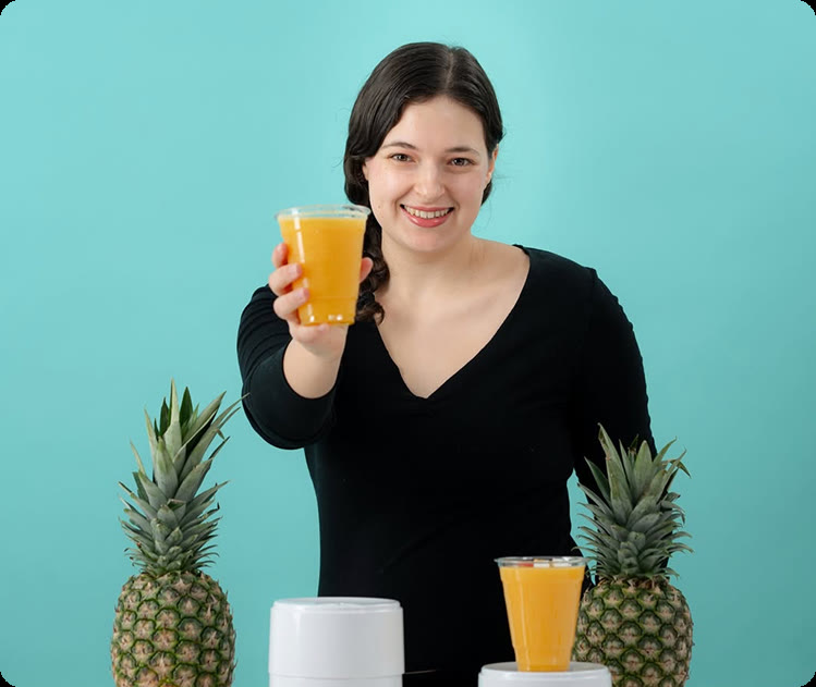 A Caterlush creator holding a fresh pineapple drink